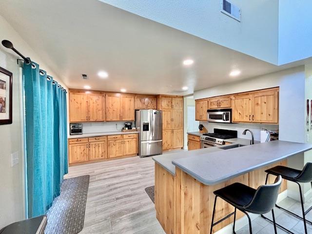 820 Talbot Drive Hollister, CA 95023 - Photo 6 of 27 a kitchen with stainless steel appliances a dining table chairs and granite counter tops