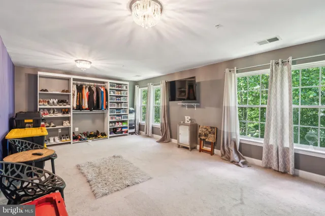 a view of a livingroom with furniture and a flat screen tv