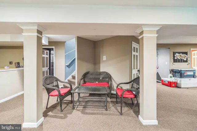 a living room with furniture a flat screen tv and a table