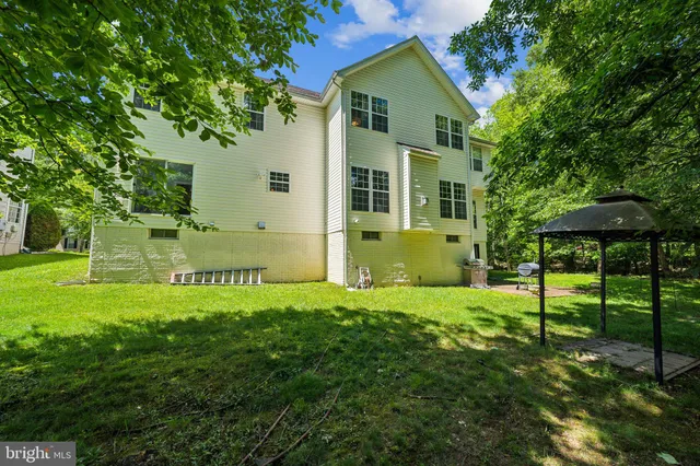a view of a chairs and table in backyard