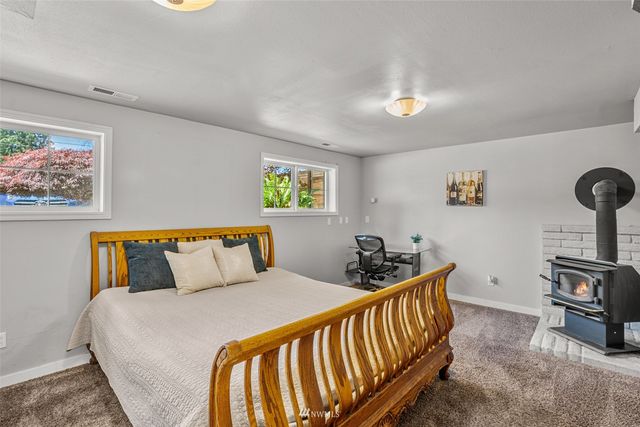 a bedroom with furniture and a flat screen tv