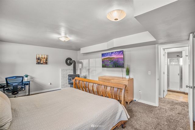 a view of bathroom with a potted plant on the counter and a sink