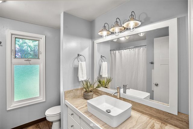 a bedroom with a large bed and a potted plant