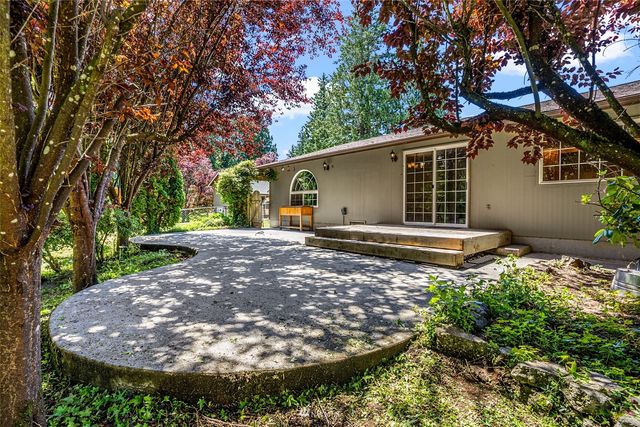 a big yard with lots of green space and house in the back
