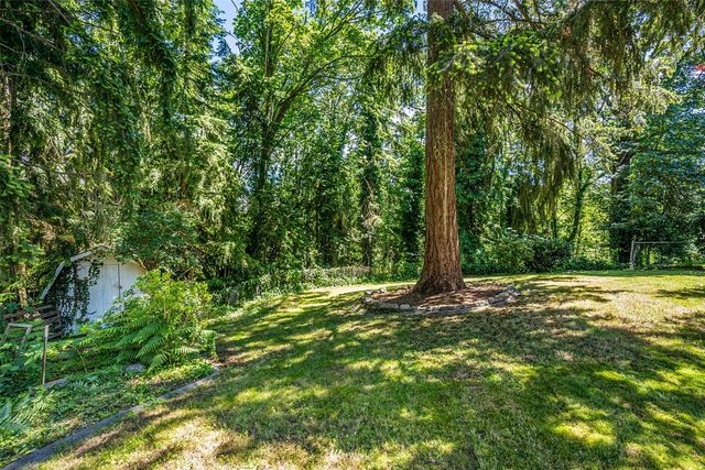 a view of backyard of house with green space