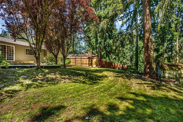 a view of a house with a yard and sitting area