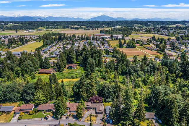 an aerial view of a house with yard swimming pool and outdoor seating