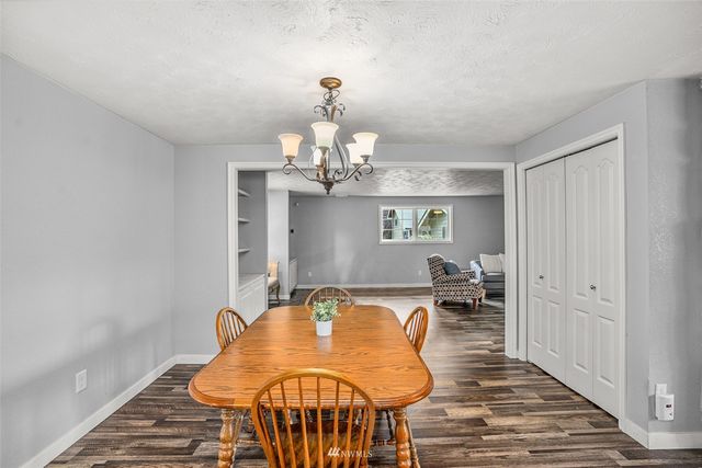 a dining room with furniture a rug and wooden floor