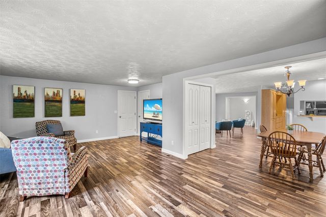 a bedroom with furniture and a wooden floor