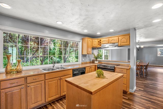 a kitchen with a stove a sink and a refrigerator