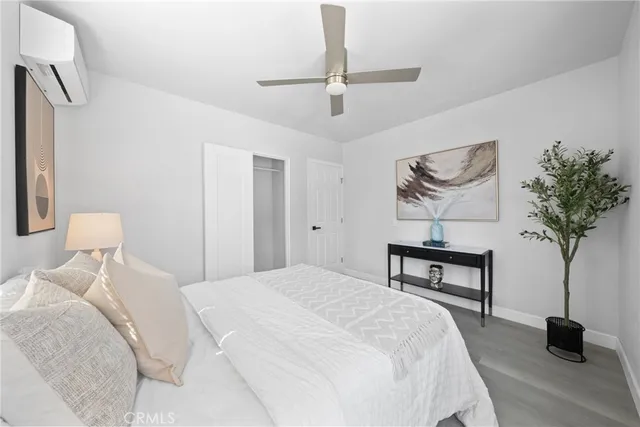 a bedroom with a bed and a potted plant