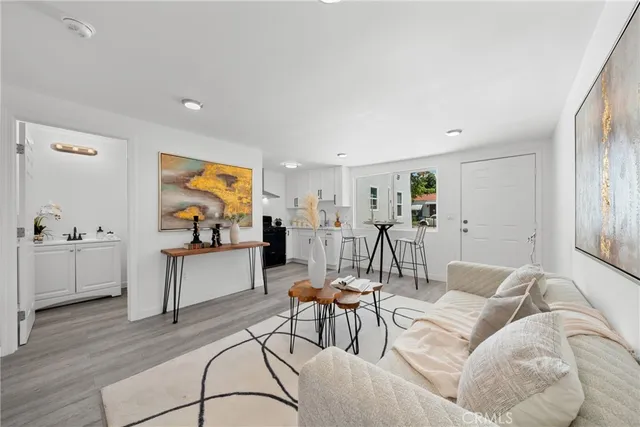 a living room with furniture and kitchen view