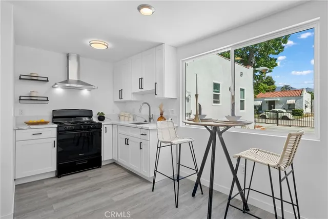 a kitchen with stainless steel appliances a stove a sink dishwasher and a refrigerator