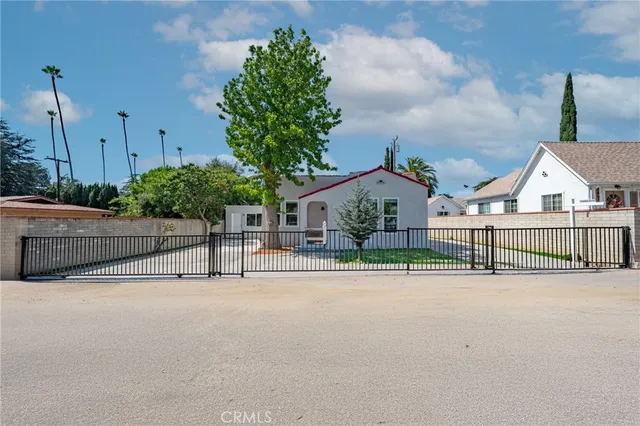 a view of a brick house in front of a yard