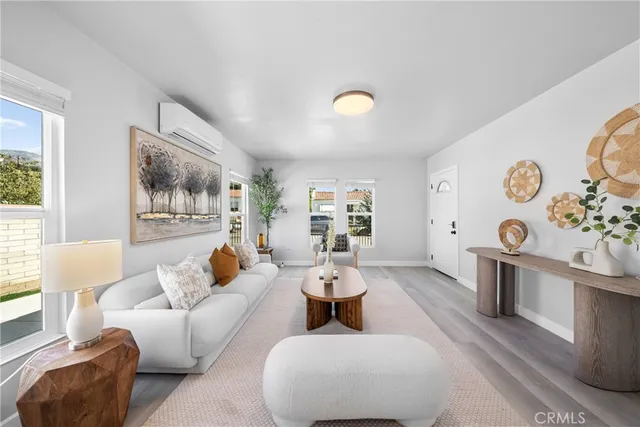 a living room with furniture and wooden floor
