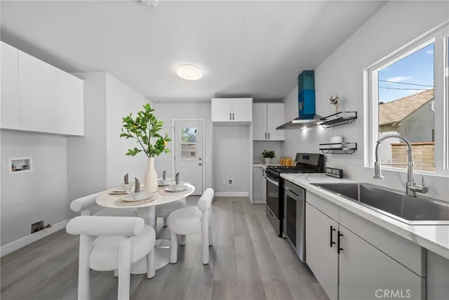 a kitchen with granite countertop a sink cabinets and stainless steel appliances