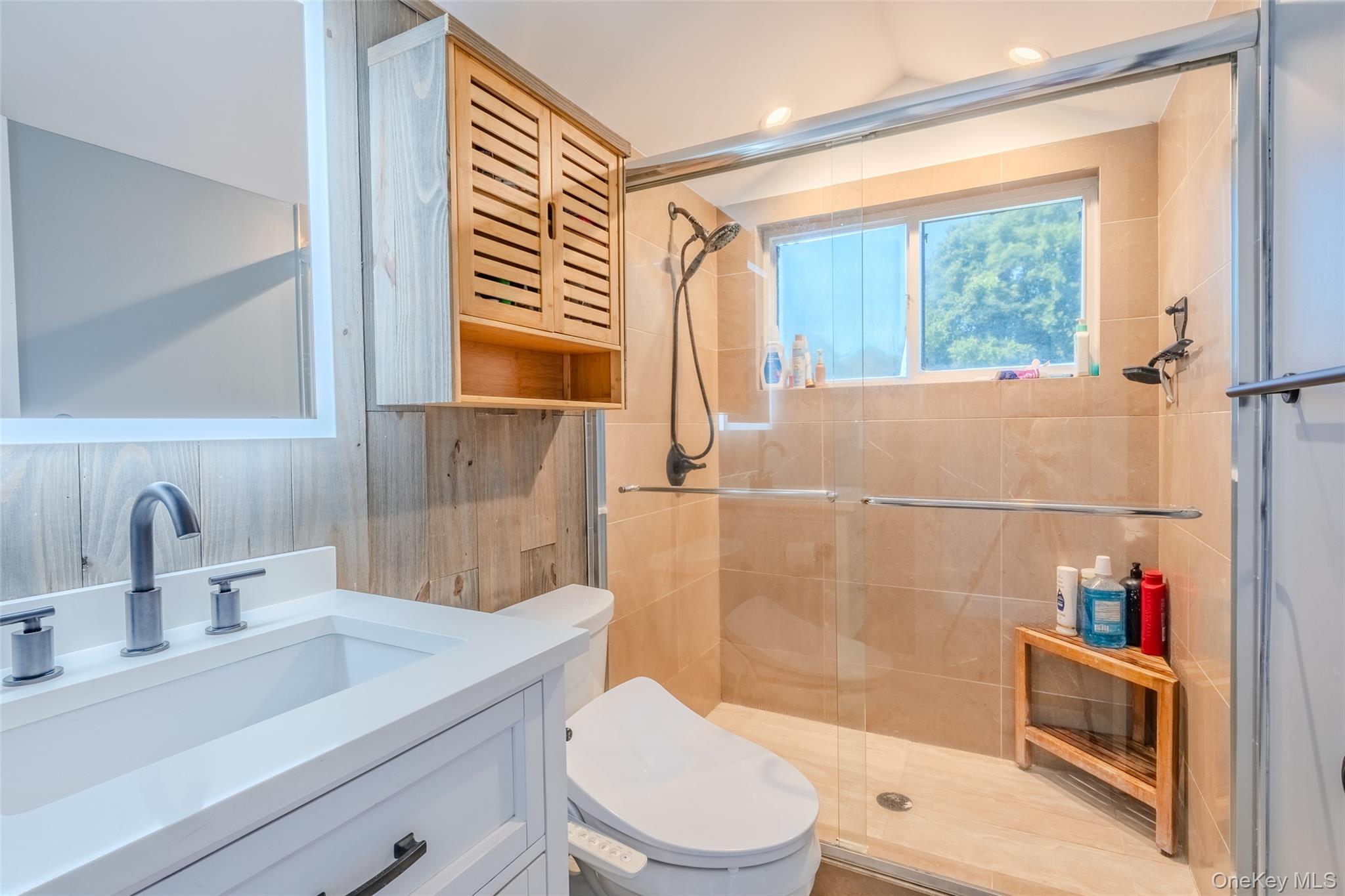 53 Old Neck Road South Center Moriches, NY 11934 - Photo 11 of 50 a bathroom with a sink a toilet and shower
