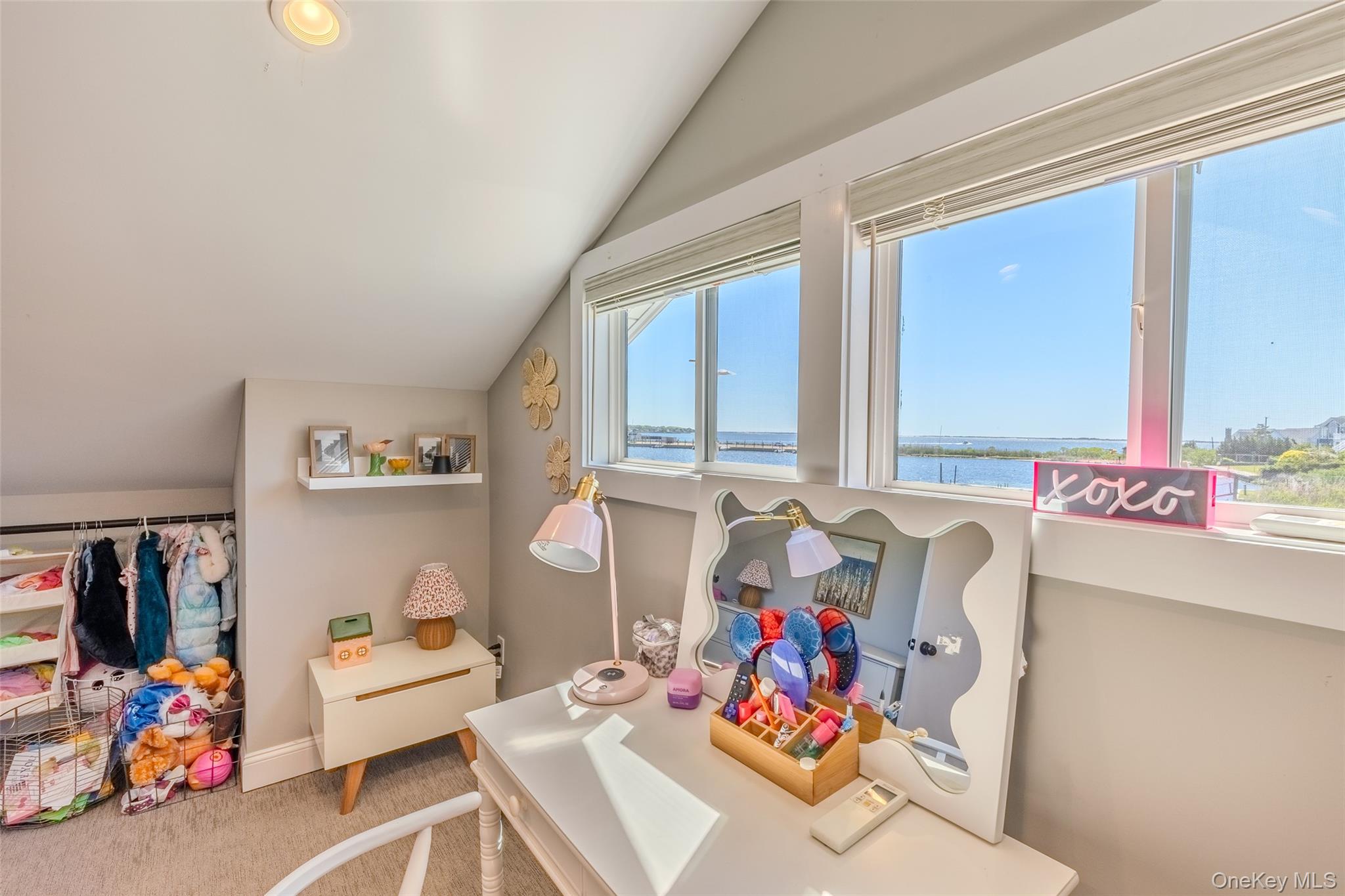 53 Old Neck Road South Center Moriches, NY 11934 - Photo 13 of 50 Playroom featuring lofted ceiling, carpet floors, a water view, and baseboards
