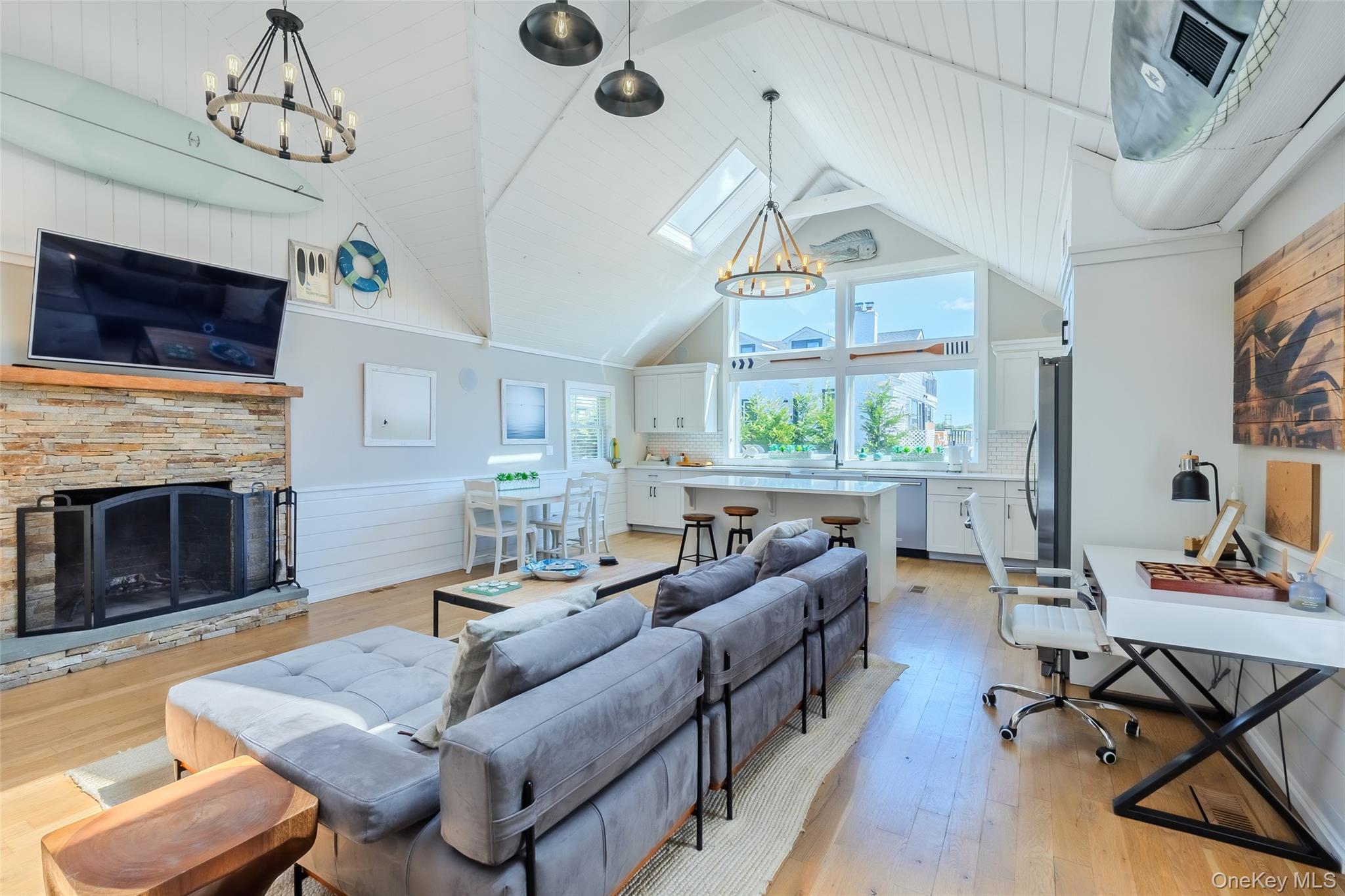 53 Old Neck Road South Center Moriches, NY 11934 - Photo 20 of 50 a living room with furniture a fireplace and a flat screen tv