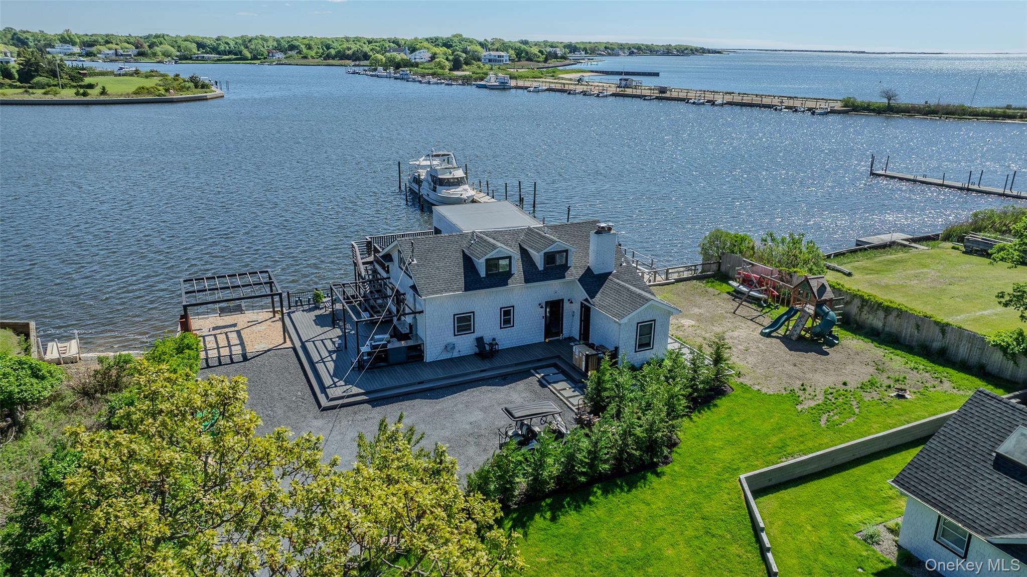 53 Old Neck Road South Center Moriches, NY 11934 - Photo 2 of 50 an aerial view of a house with a lake view