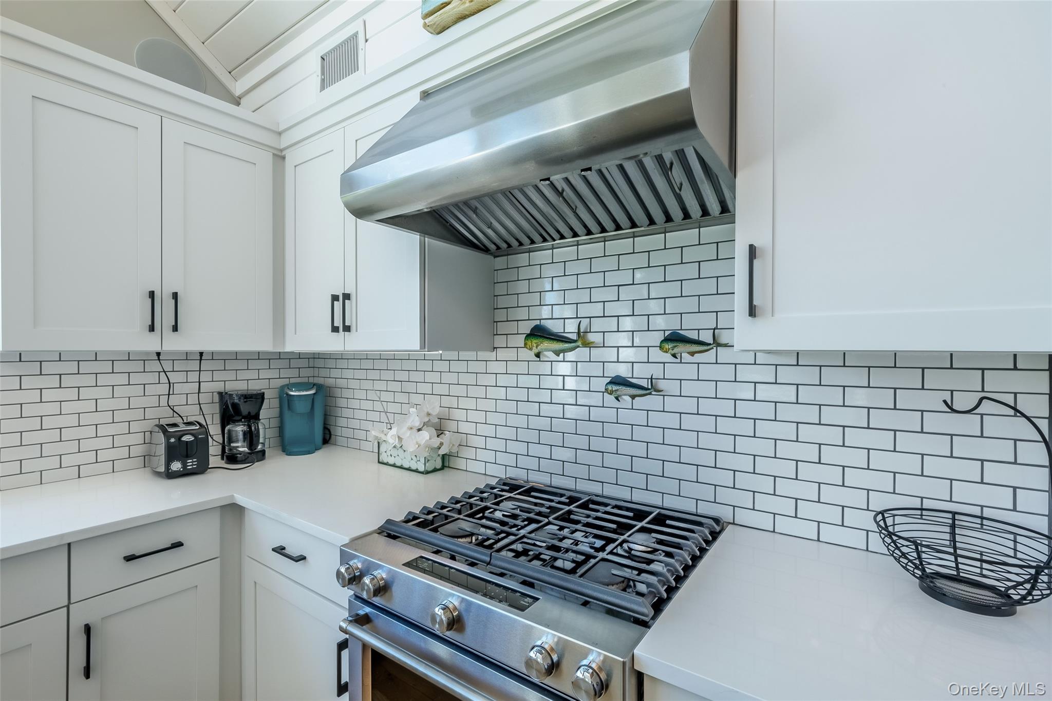 53 Old Neck Road South Center Moriches, NY 11934 - Photo 21 of 50 a kitchen with a stove and cabinets