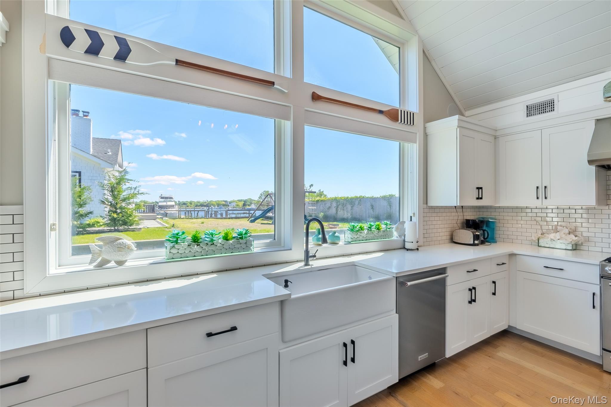 53 Old Neck Road South Center Moriches, NY 11934 - Photo 22 of 50 a kitchen with a window a sink and cabinets