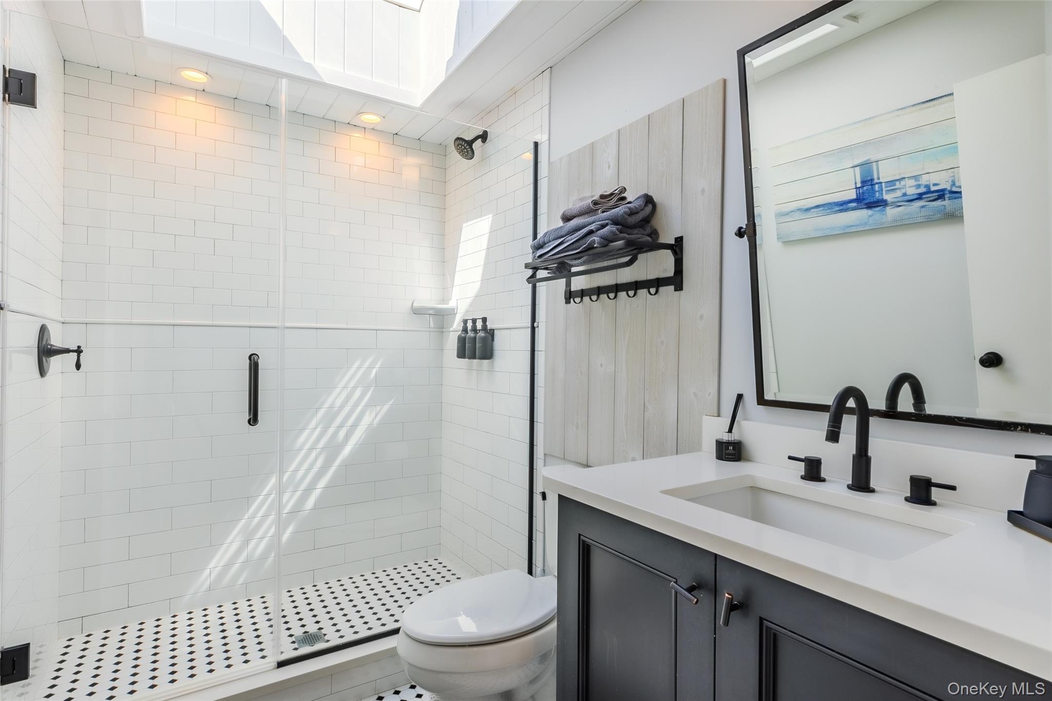 53 Old Neck Road South Center Moriches, NY 11934 - Photo 25 of 50 a bathroom with a sink a toilet and shower