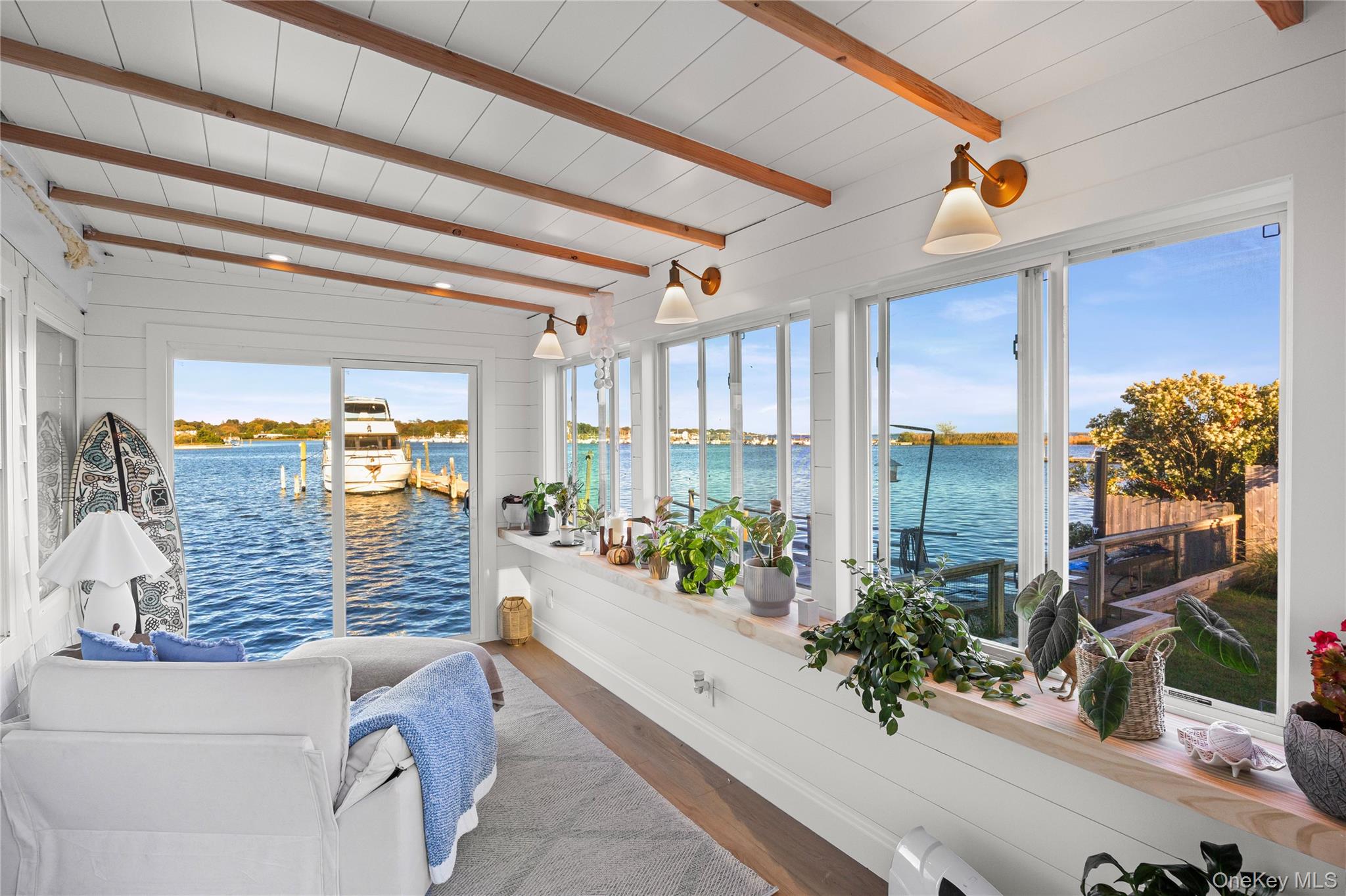53 Old Neck Road South Center Moriches, NY 11934 - Photo 5 of 50 Sunroom / solarium with beam ceiling, wood finished floors, and a water view