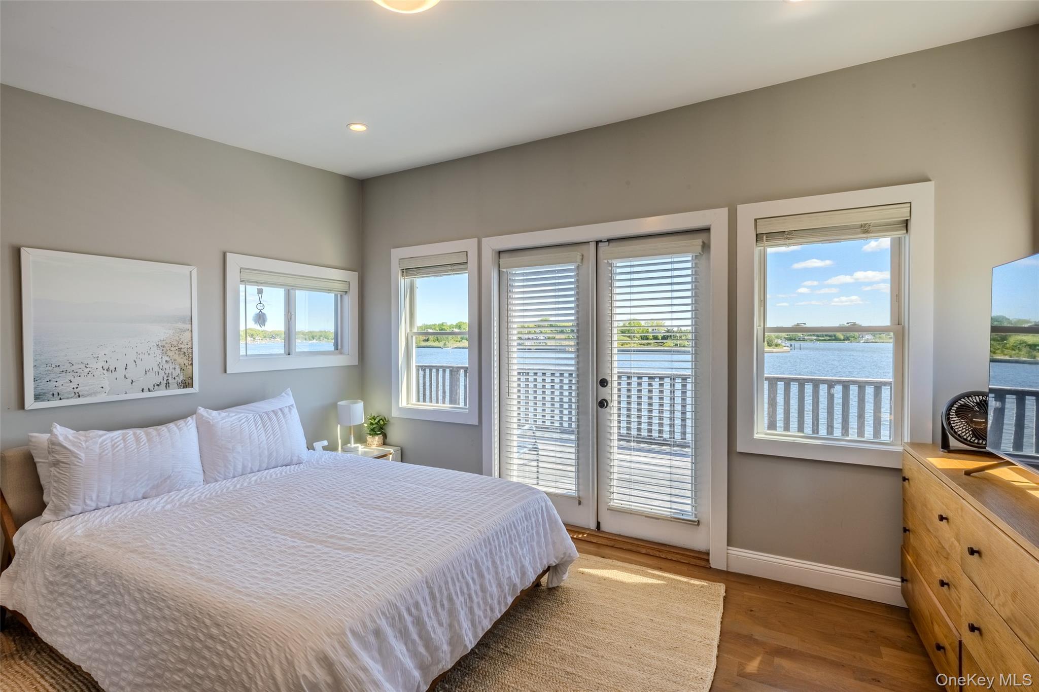 53 Old Neck Road South Center Moriches, NY 11934 - Photo 10 of 50 Bedroom featuring access to exterior, baseboards, wood finished floors, recessed lighting, and french doors