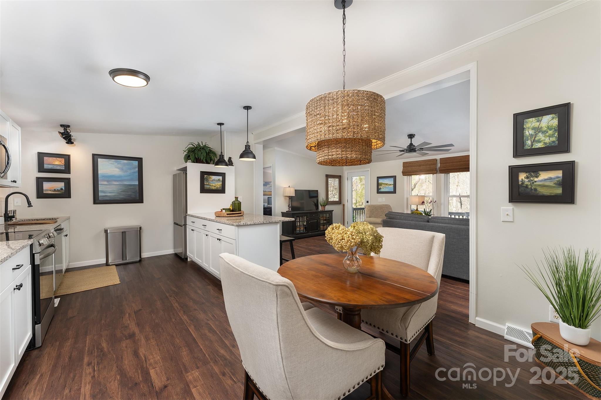 55 Whitaker Circle Fairview, NC 28730 - Photo 11 of 45 a view of a dining room with furniture wooden floor and chandelier