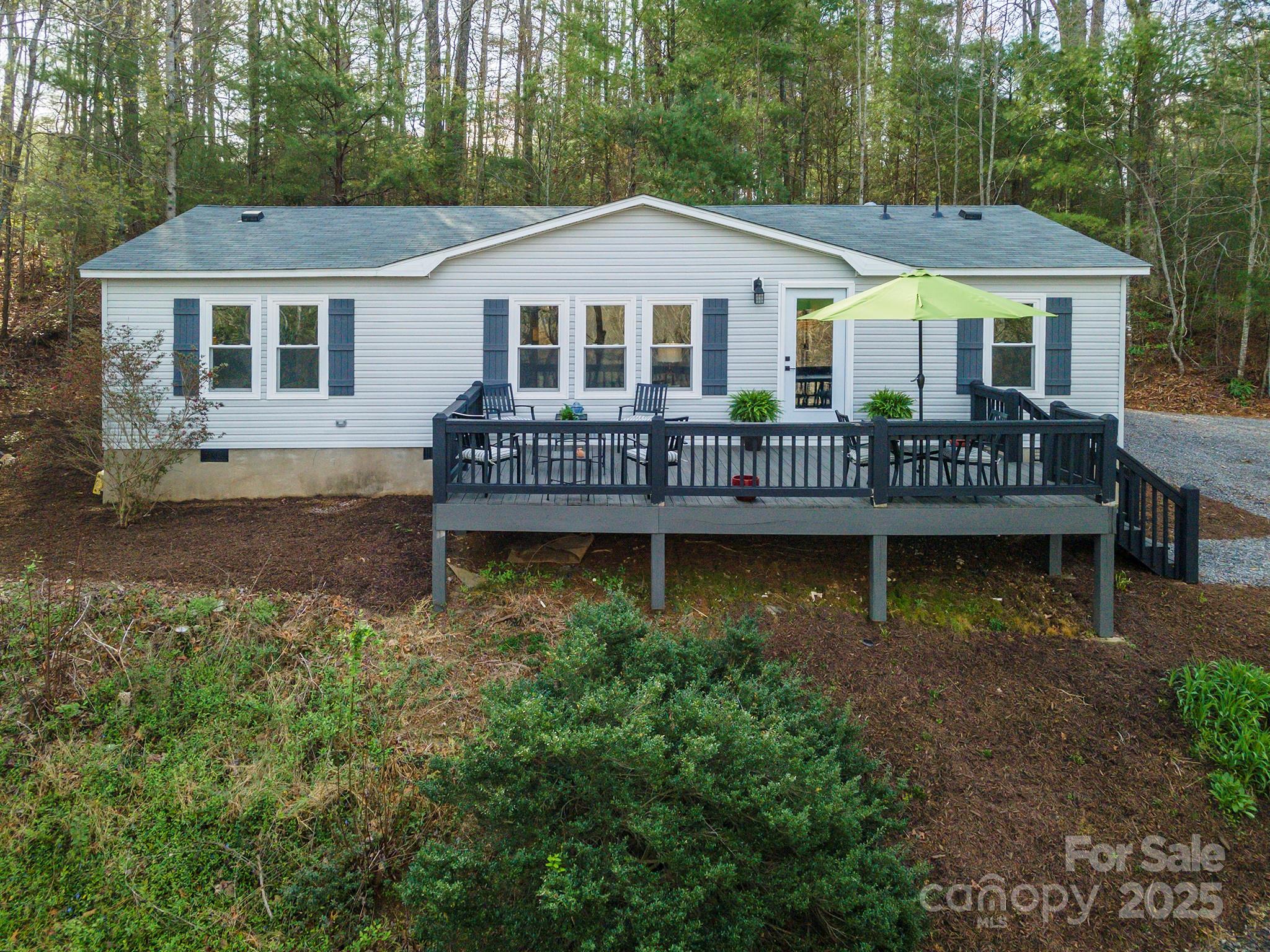55 Whitaker Circle Fairview, NC 28730 - Photo 2 of 45 a front view of a house with a yard table and chairs