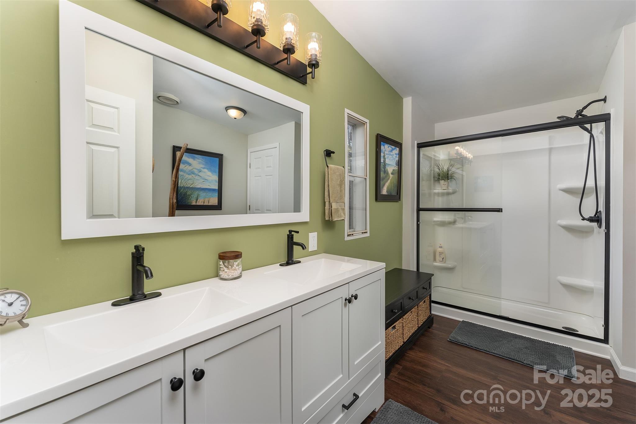 55 Whitaker Circle Fairview, NC 28730 - Photo 24 of 45 a bathroom with a sink a mirror and a shower