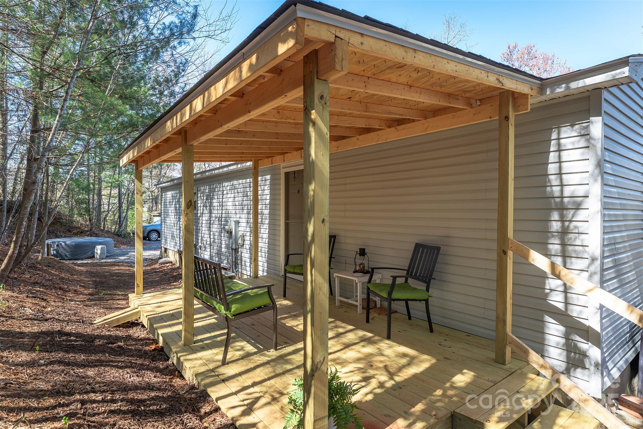 55 Whitaker Circle Fairview, NC 28730 - Photo 32 of 45 a view of a patio with a table and chairs and potted plants