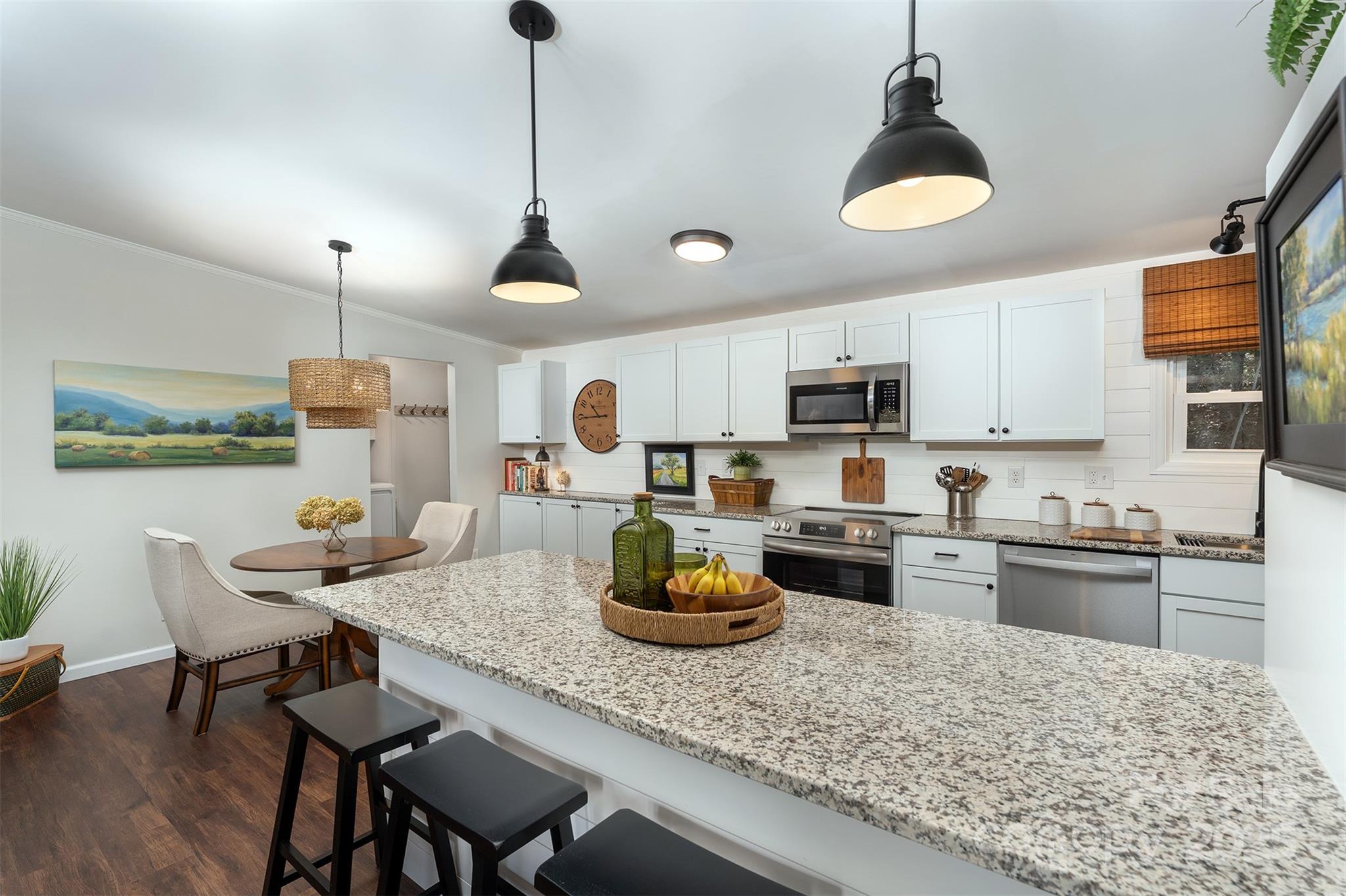 55 Whitaker Circle Fairview, NC 28730 - Photo 5 of 45 a kitchen with granite countertop kitchen island stainless steel appliances a stove sink and cabinets