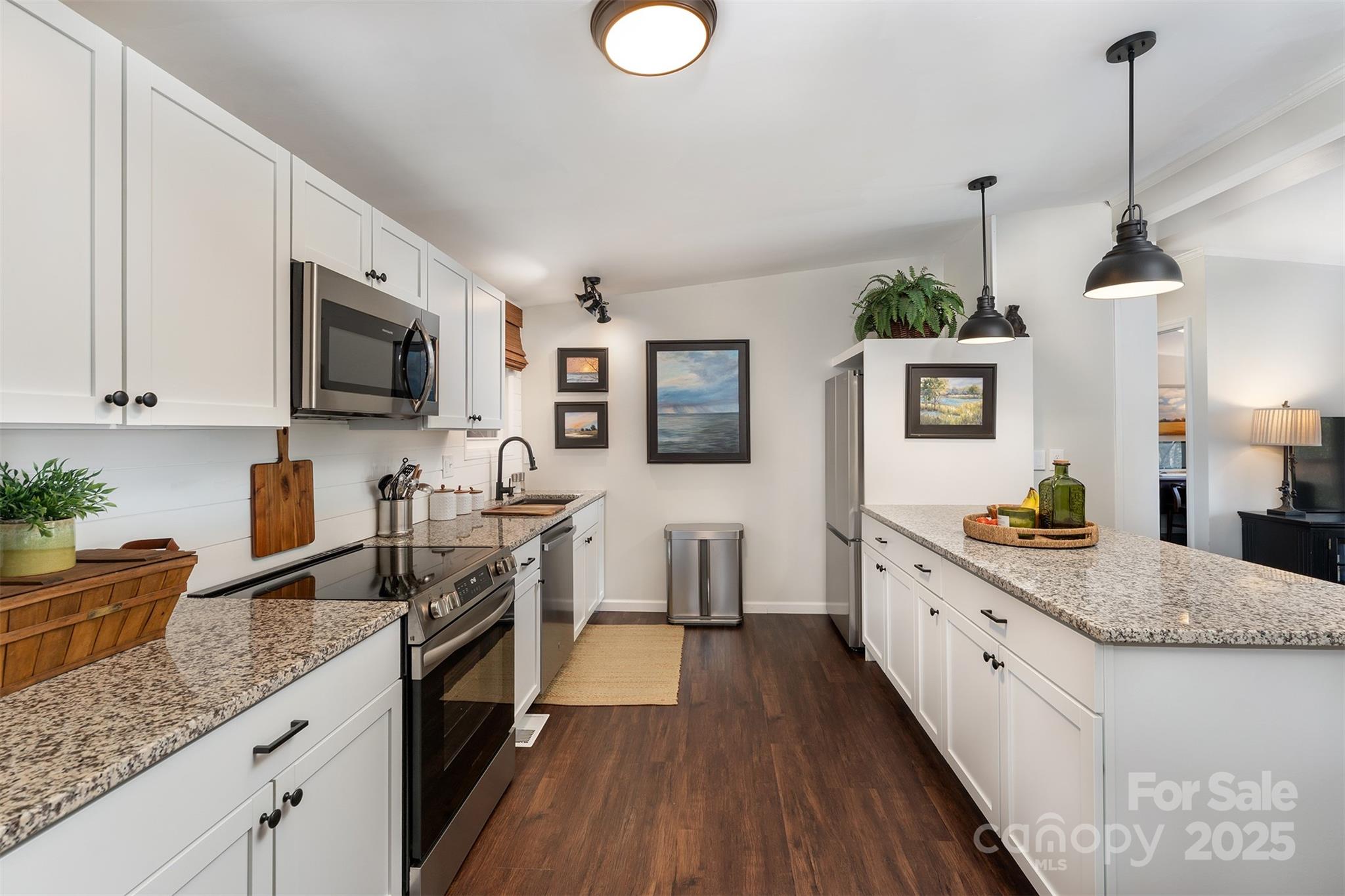 55 Whitaker Circle Fairview, NC 28730 - Photo 9 of 45 a kitchen with stainless steel appliances granite countertop a sink stove and refrigerator