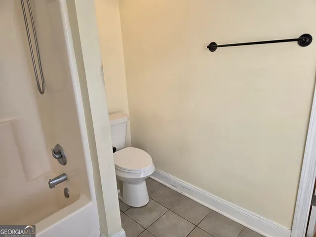 a white toilet sitting next to a sink