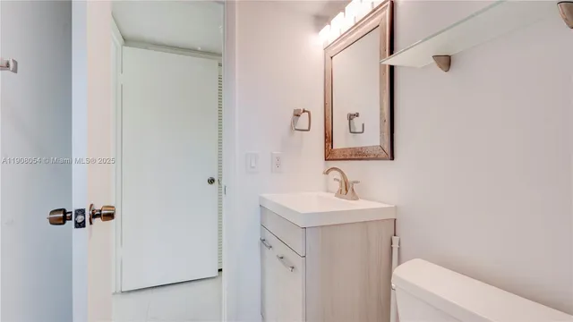 a bathroom with double vanity and a mirror