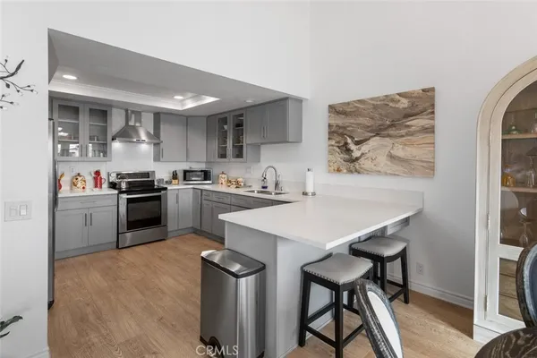 a kitchen with a table chairs refrigerator and cabinets