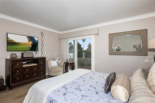 a bedroom with a bed and a flat screen tv