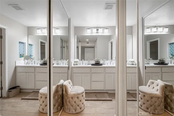 a bathroom with a sink vanity and mirror