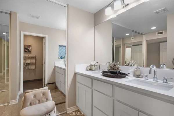 a bathroom with a sink and mirror with toilet