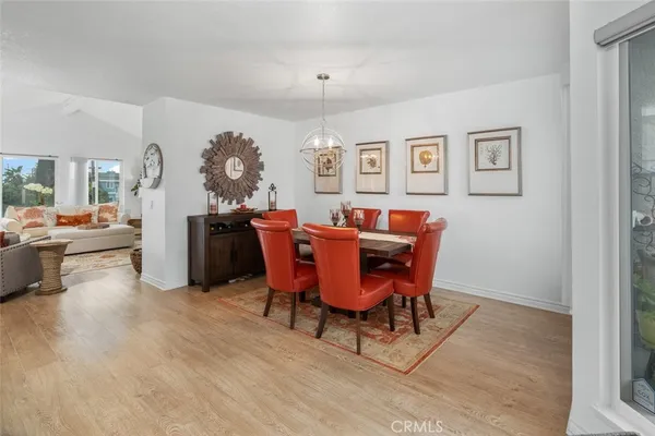 a view of a dining room with furniture and chandelier