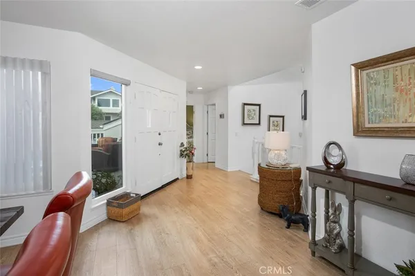 a furnished livingroom with a window and workspace