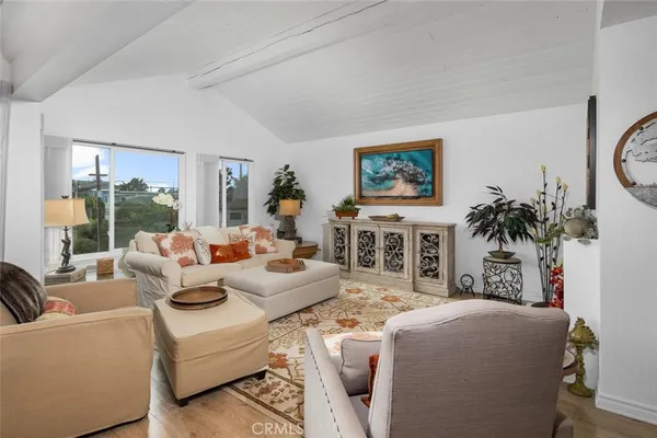 a living room with furniture a fireplace and a potted plant
