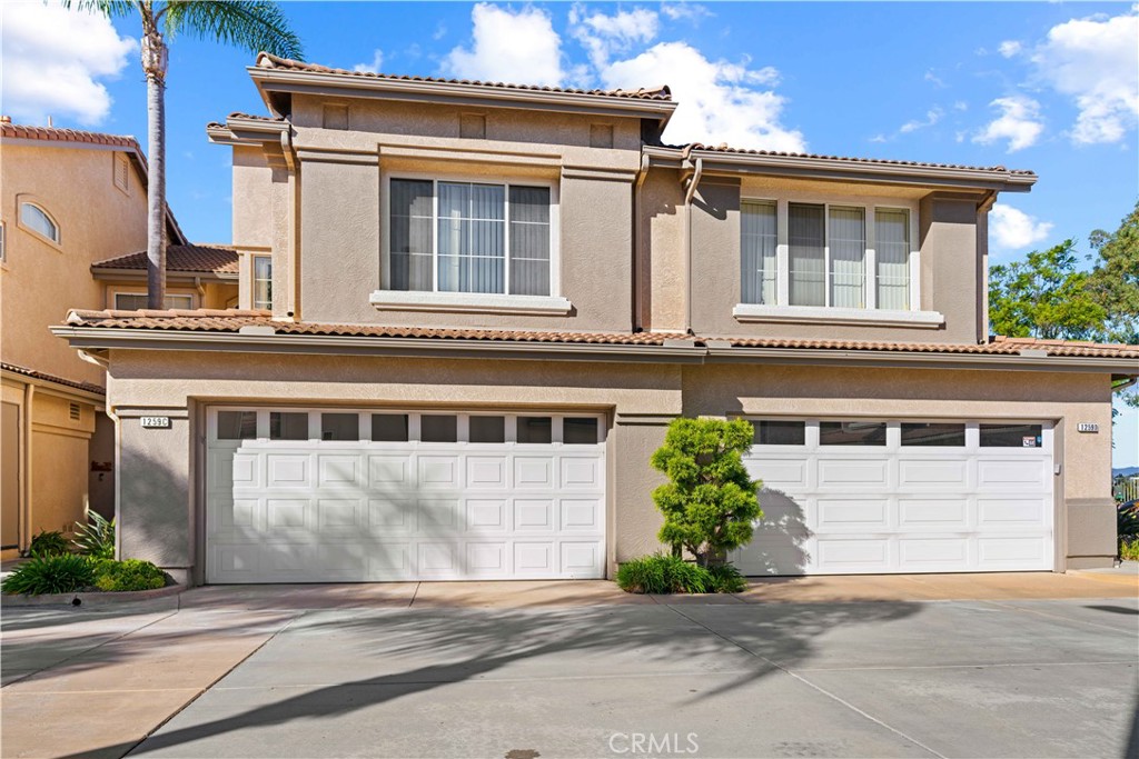 1259 Natoma Way, Unit C Oceanside, CA 92057 - Photo 1 of 1 a front view of a house with a yard and garage