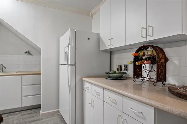 a kitchen with sink cabinets and refrigerator