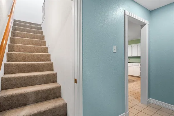 a view of staircase with empty shelves