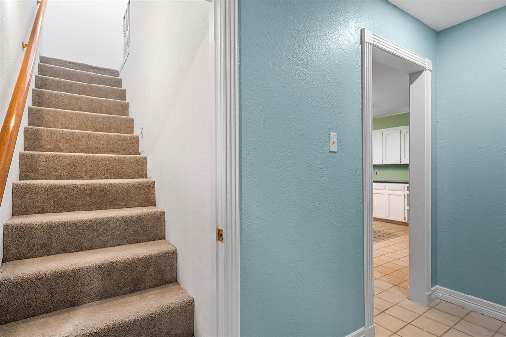 544 Lusk Creek Road Eddy, TX 76524 - Photo 24 of 39 Staircase with a textured wall and tile patterned flooring