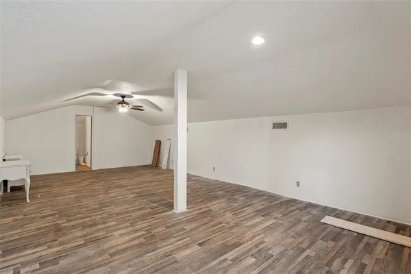a view of a room with wooden floor