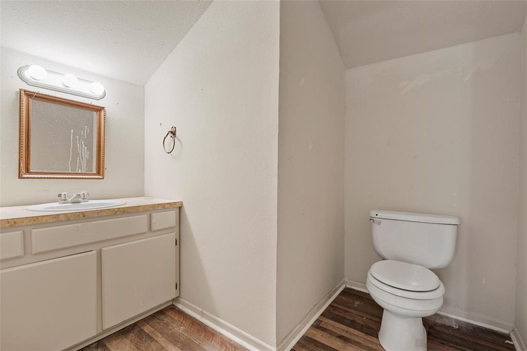 544 Lusk Creek Road Eddy, TX 76524 - Photo 27 of 39 Bathroom featuring vanity, dark wood-style flooring, and vaulted ceiling